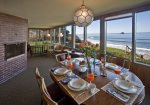 Living and dining rooms look toward a panoramic view of the ocean